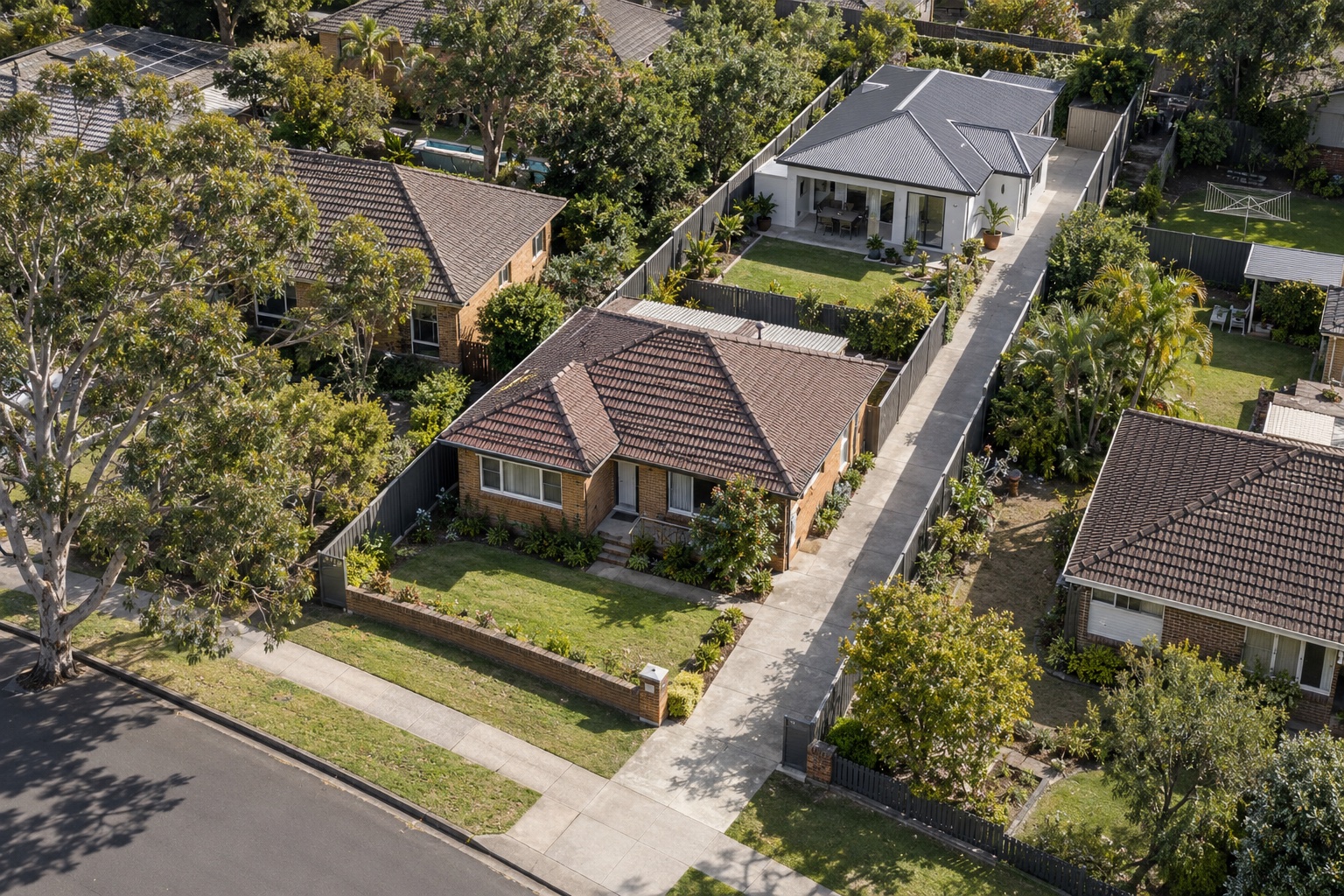 Subdivided residential lot with an original front house, a new rear house and a side driveway